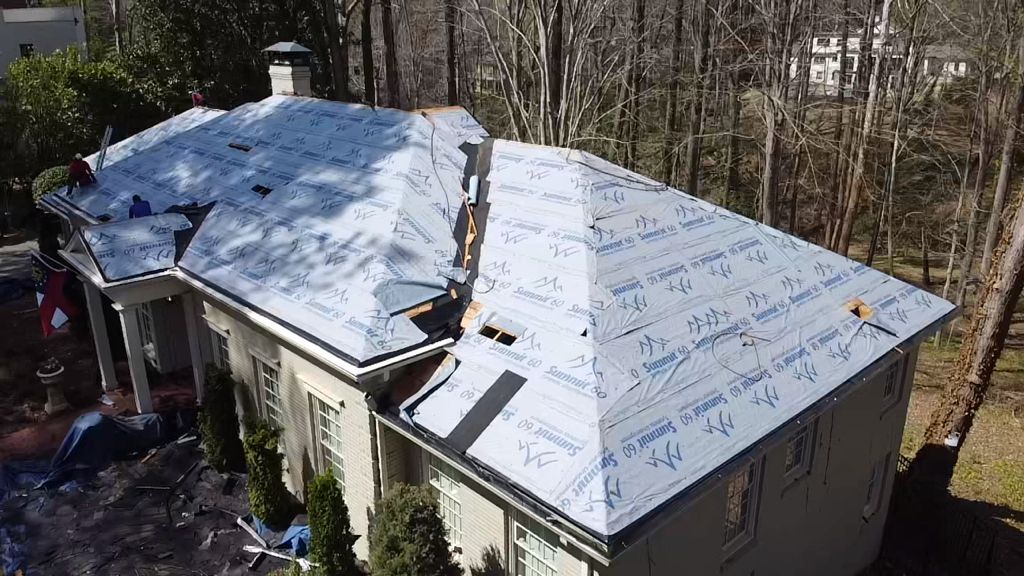 An aerial view of a house with a roof being installed.