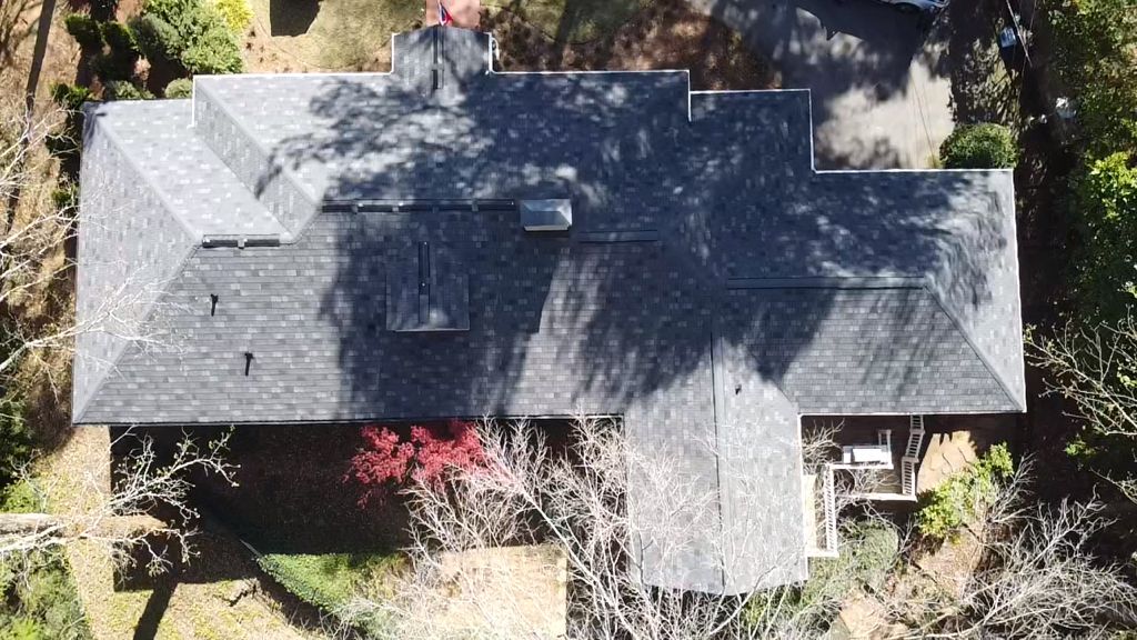 An aerial view of a large house surrounded by trees.