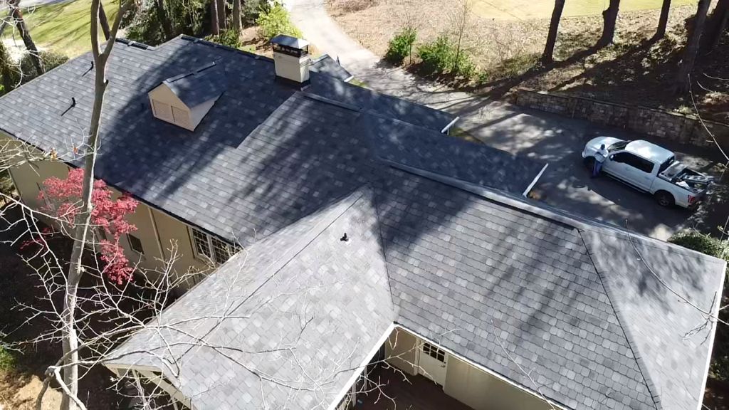 An aerial view of a house with a car parked in front of it.