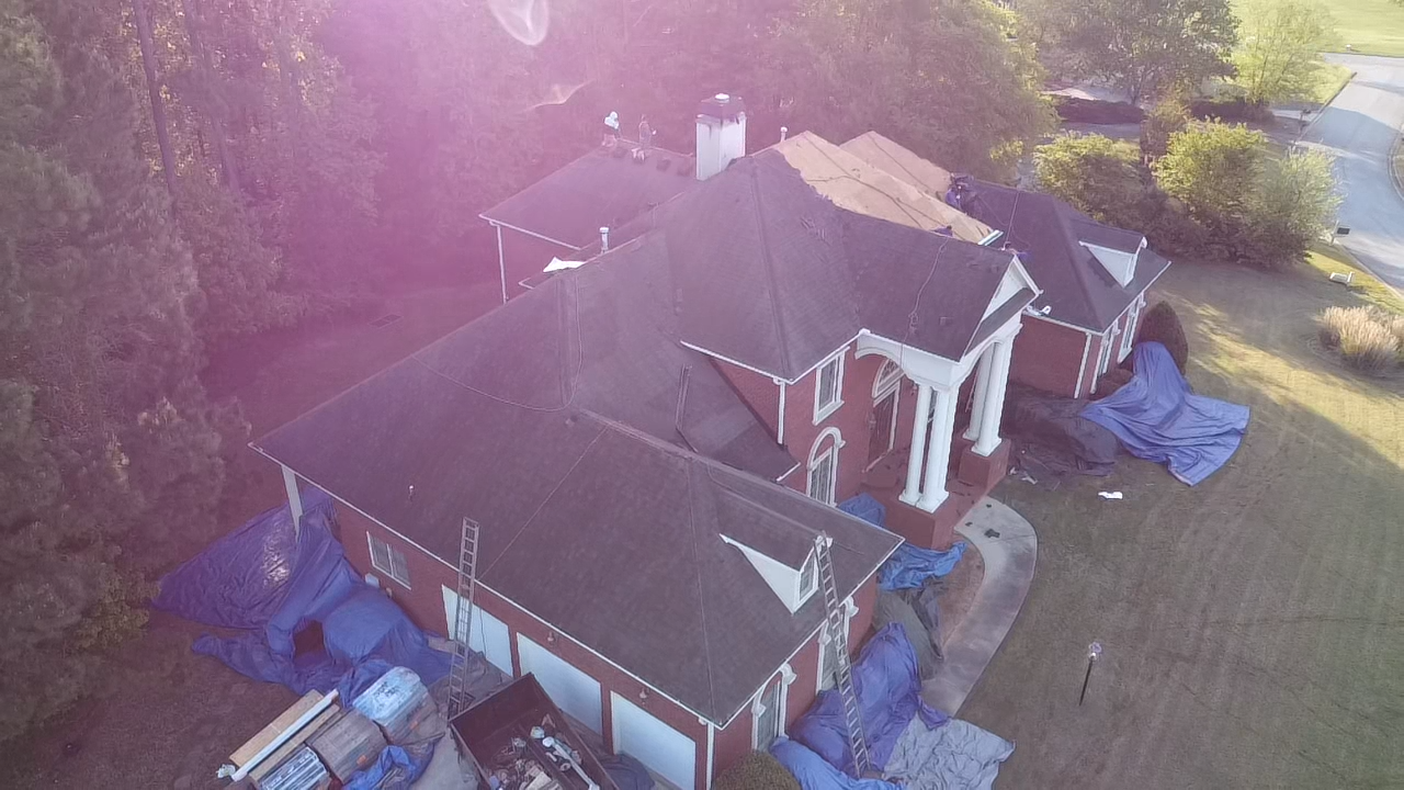 An aerial view of a large house being remodeled.