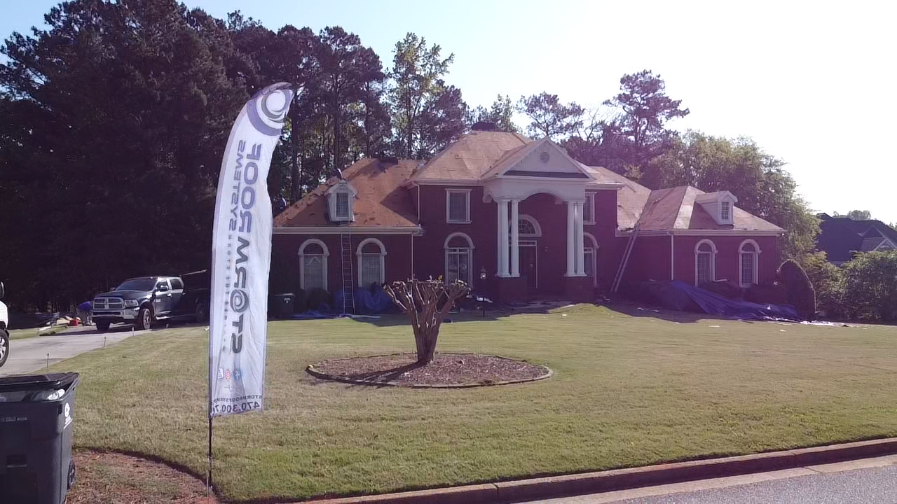A large house with a flag in front of it that says express movers