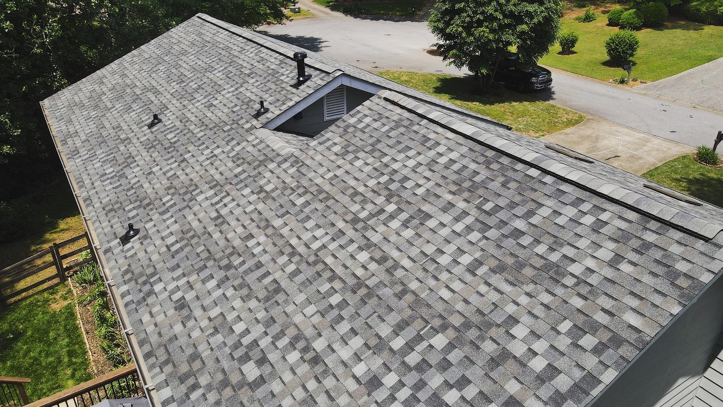 An aerial view of a roof of a house with a gray shingle roof.