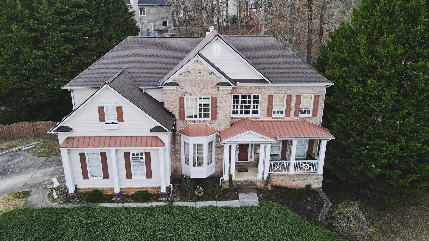 An aerial view of a large house surrounded by trees.