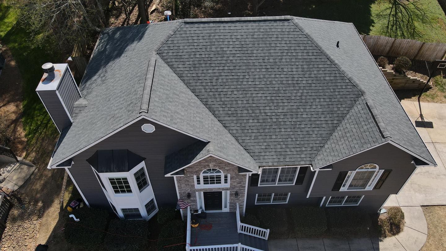 An aerial view of a house with a gray roof.