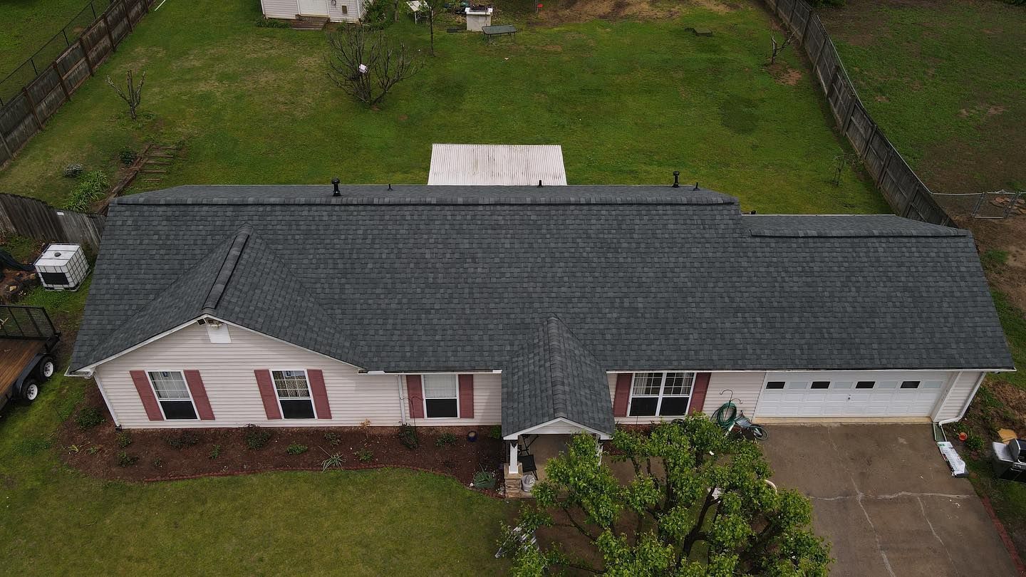 An aerial view of a house with a new roof.