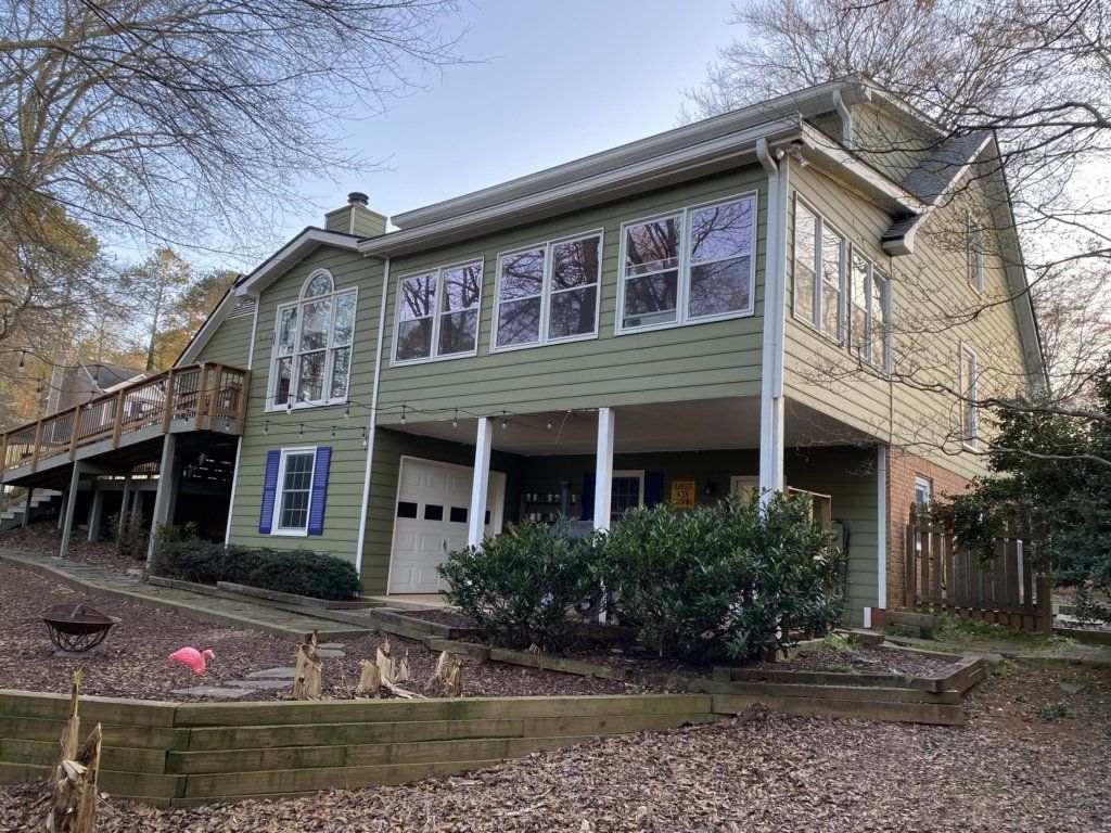 A large house with a lot of windows and a large deck.