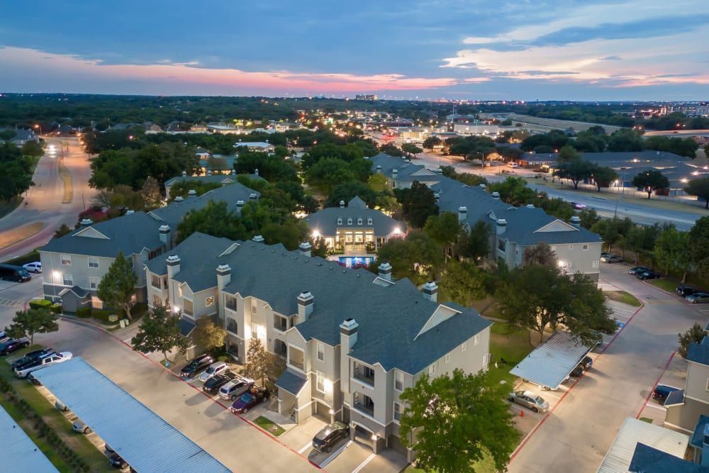 An aerial view of the apartment complex at night at Marquis at Stonegate offers apartments near Crowley, TX.