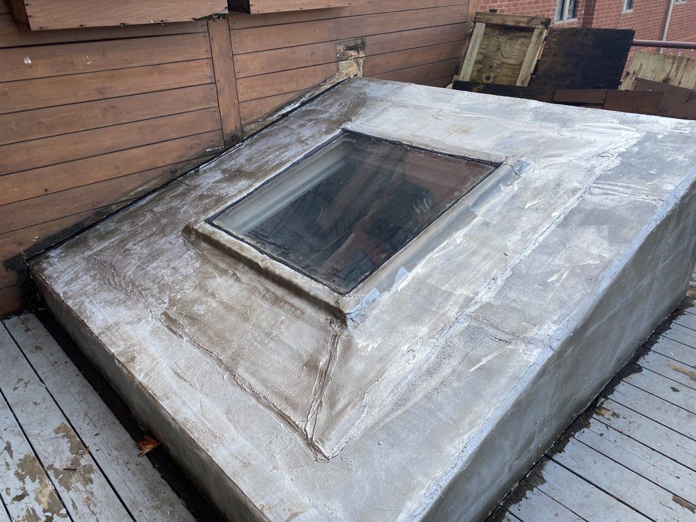 A concrete structure with a skylight on top of it.