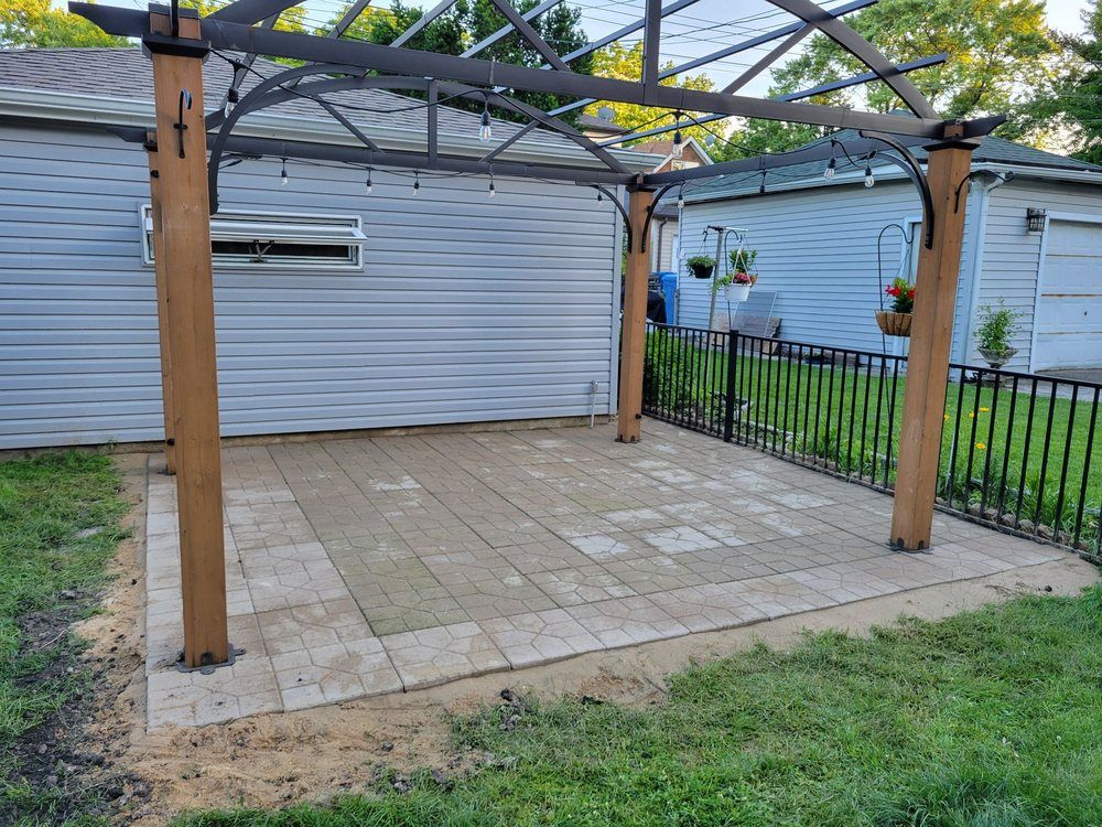 There is a pergola in the backyard of a house.