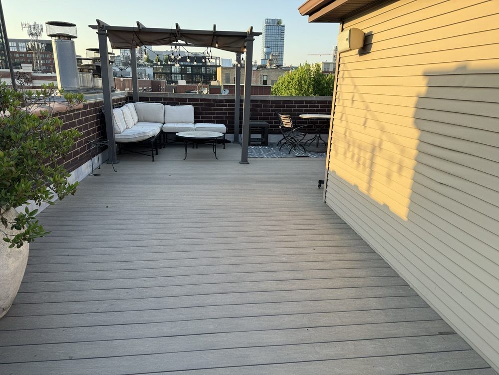 A rooftop deck with a pergola and a couch