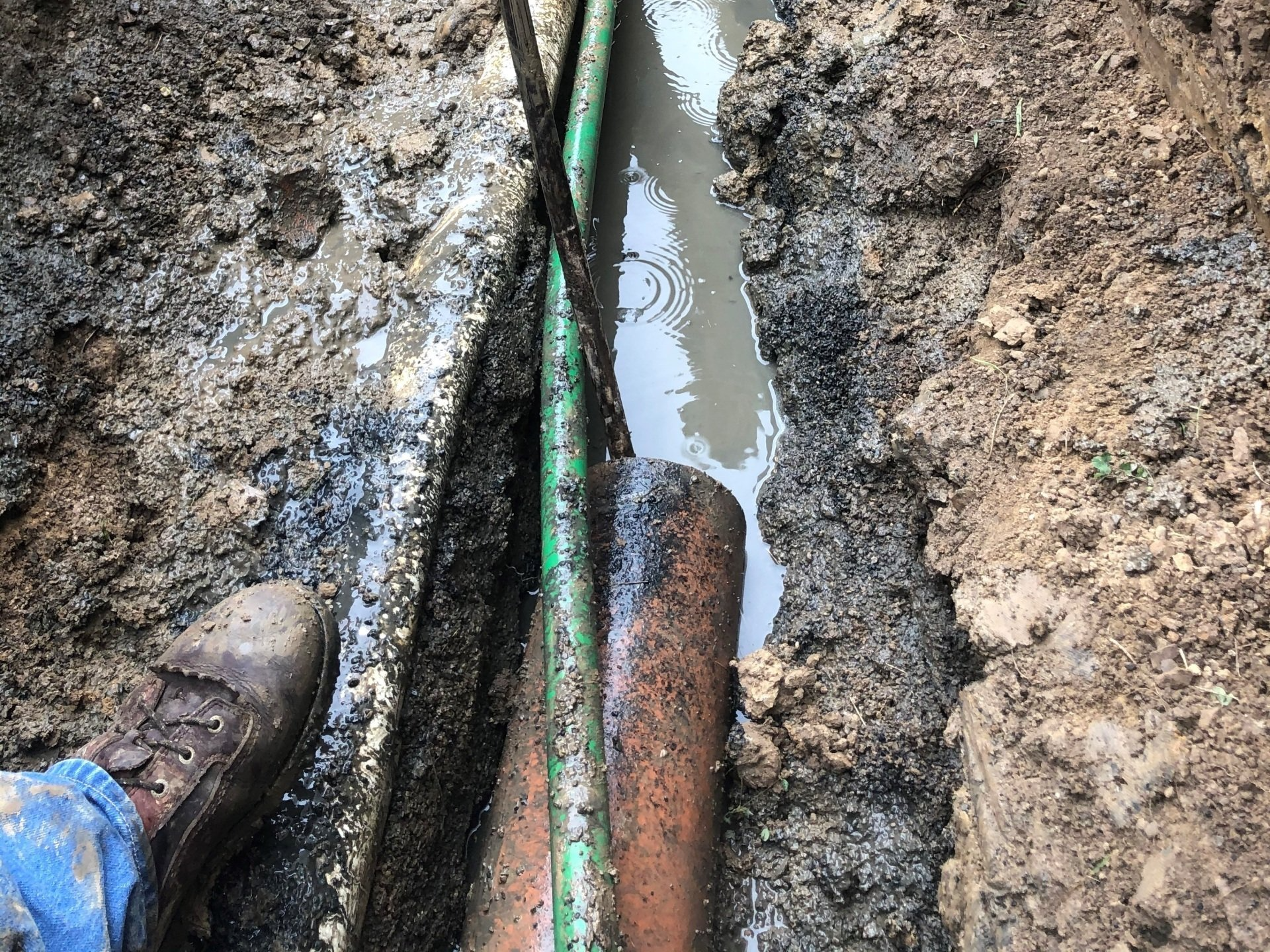 Plumber Repairing a Broken Pipe in a Septic Field — Mansfield, OH — Action Drain & Septic
