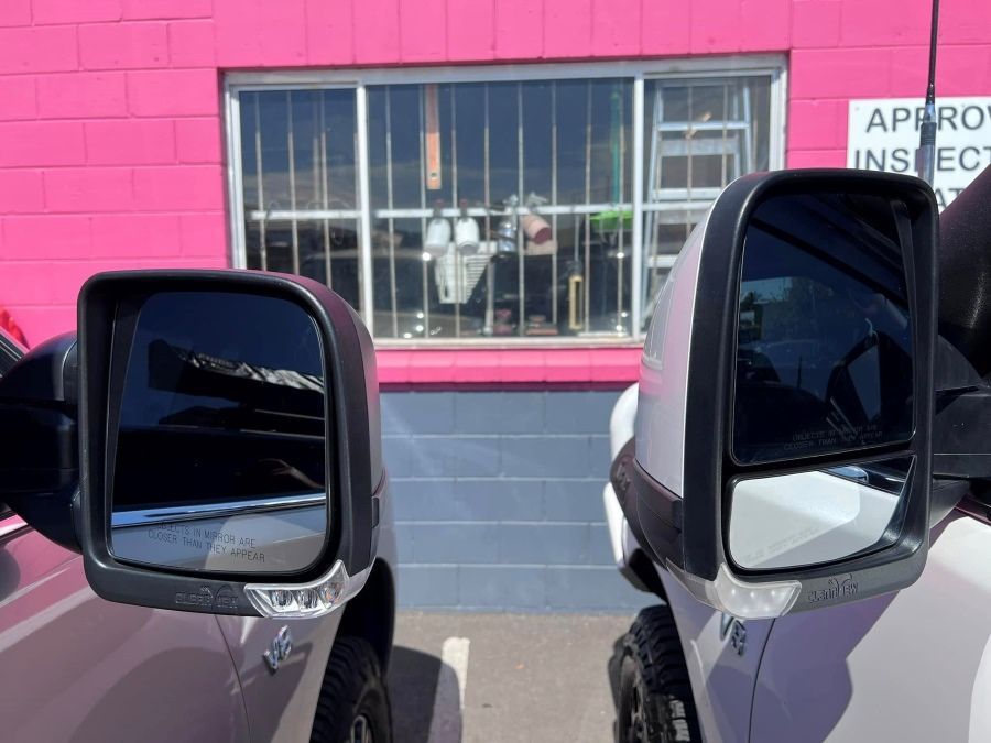 Two Cars Are Parked in Front of a Pink Brick Building — Rycam Automotive in Buderim, QLD