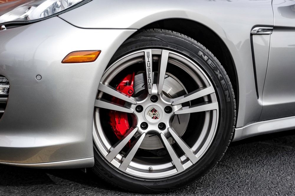 A Close Up of a Car Wheel With Red Brake Calipers — Rycam Automotive in Buderim, QLD