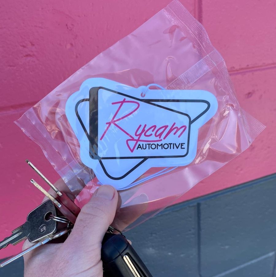 A Person is Holding a Pair of Keys in Front of a Pink Wall — Rycam Automotive in Buderim, QLD