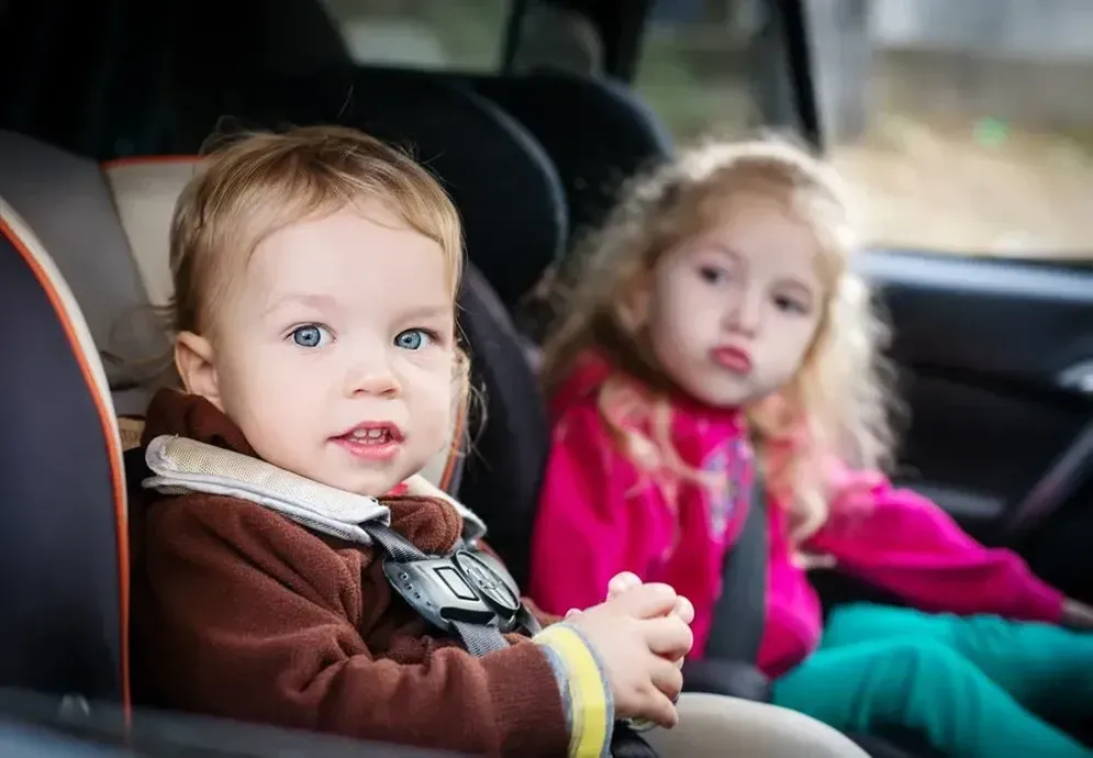 A Boy and a Girl Are Sitting in a Car Seat — Hire All in Tugun, QLD