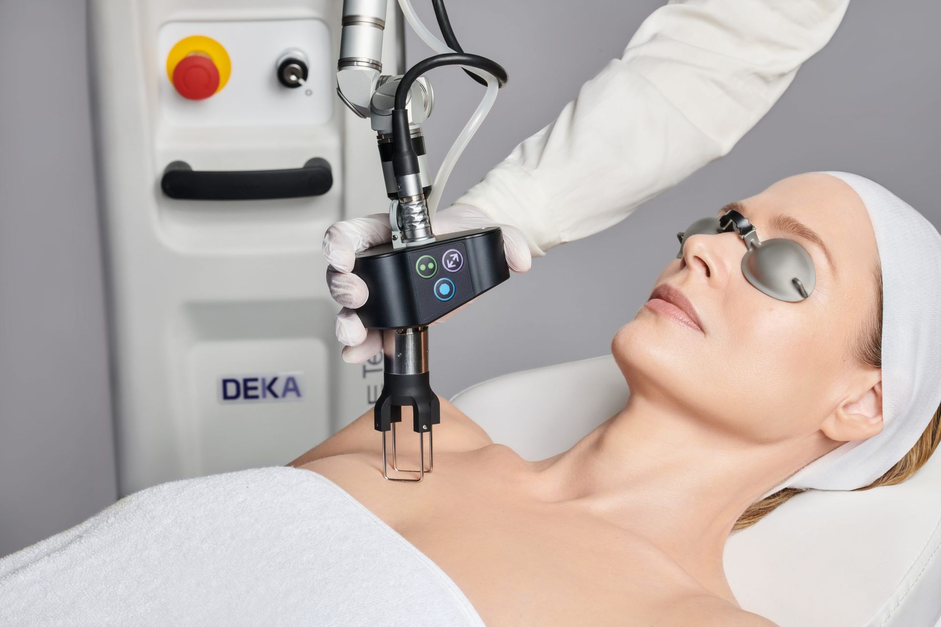 A woman is getting a laser treatment on her chest.