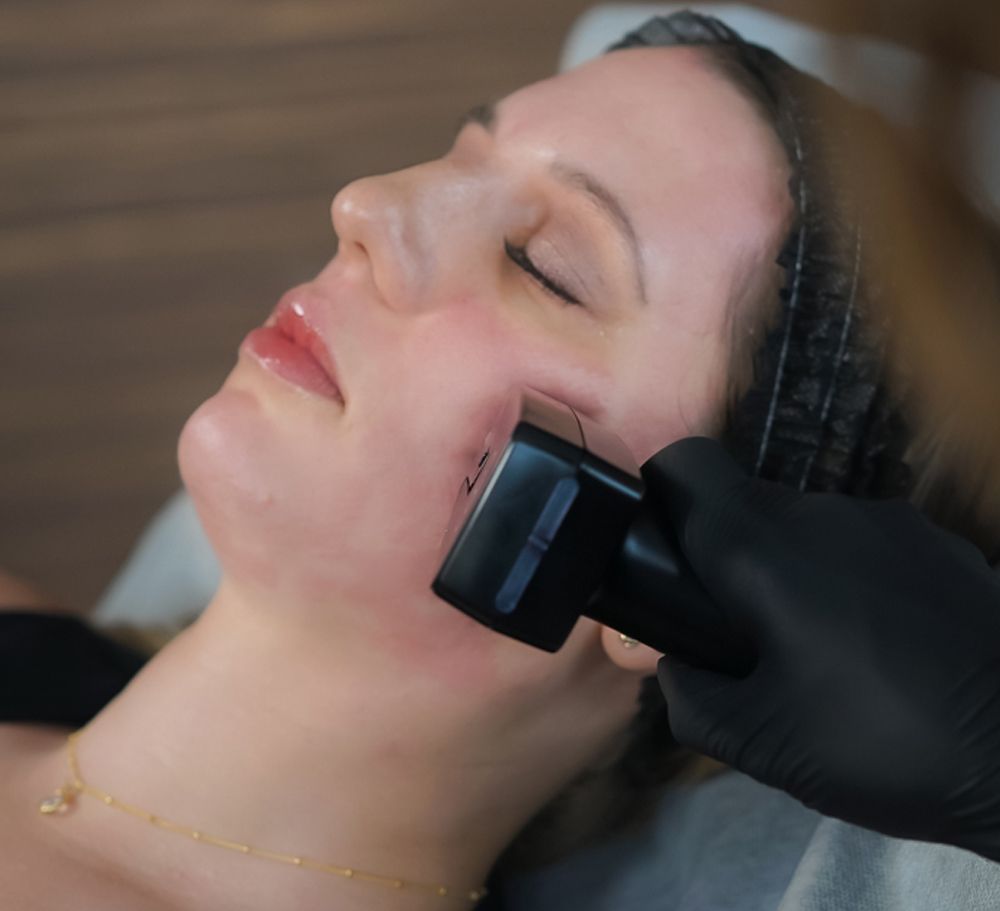 A woman is getting a treatment on her face