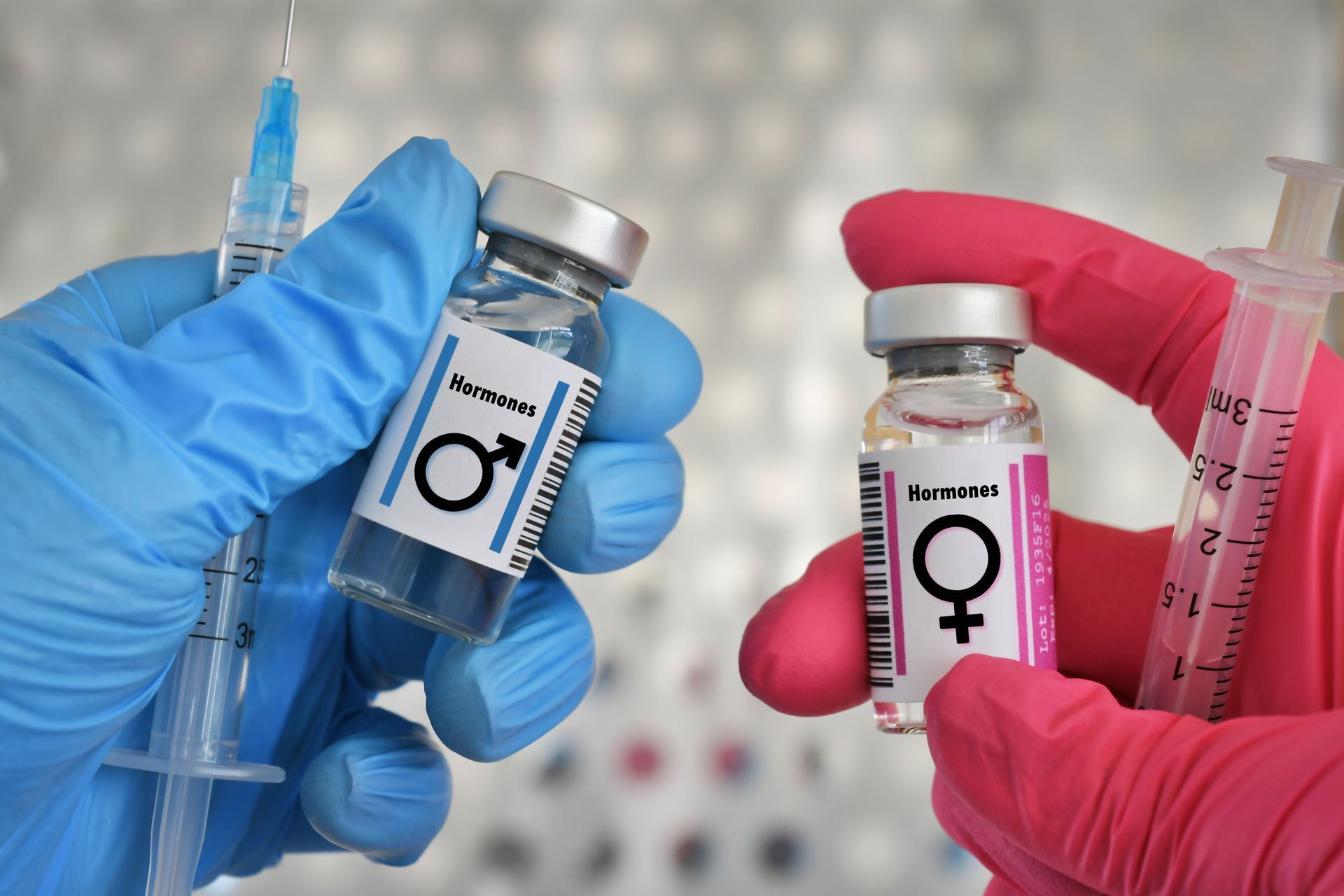 Hands in gloves holding vials with male/female symbols, and syringes.