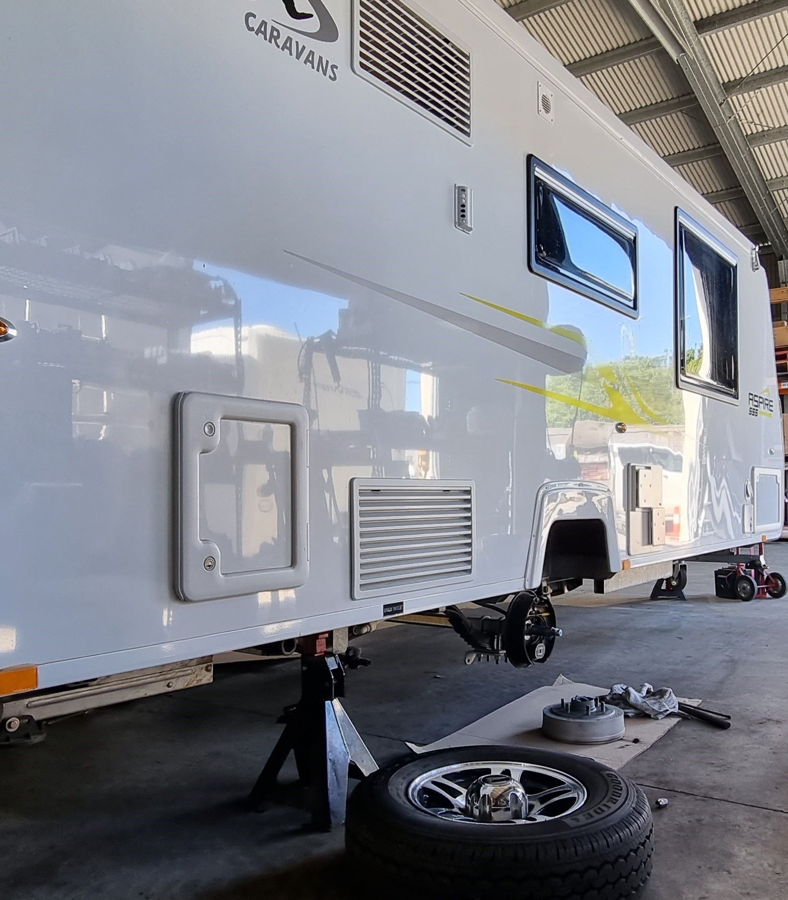 A Row of Trailers Are Parked in Front of a Building — Dempsters Caravan & RV in Thabeban, QLD