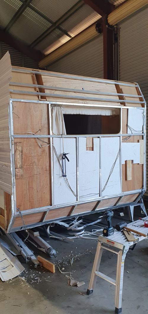 A Wooden Trailer is Being Built in a Garage — Dempsters Caravan & RV in Thabeban, QLD