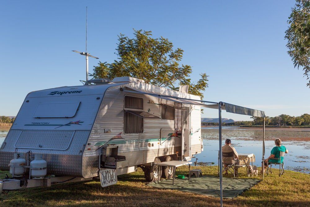 A RV is Parked Next to a Lake— Dempsters Caravan & RV in Thabeban, QLD