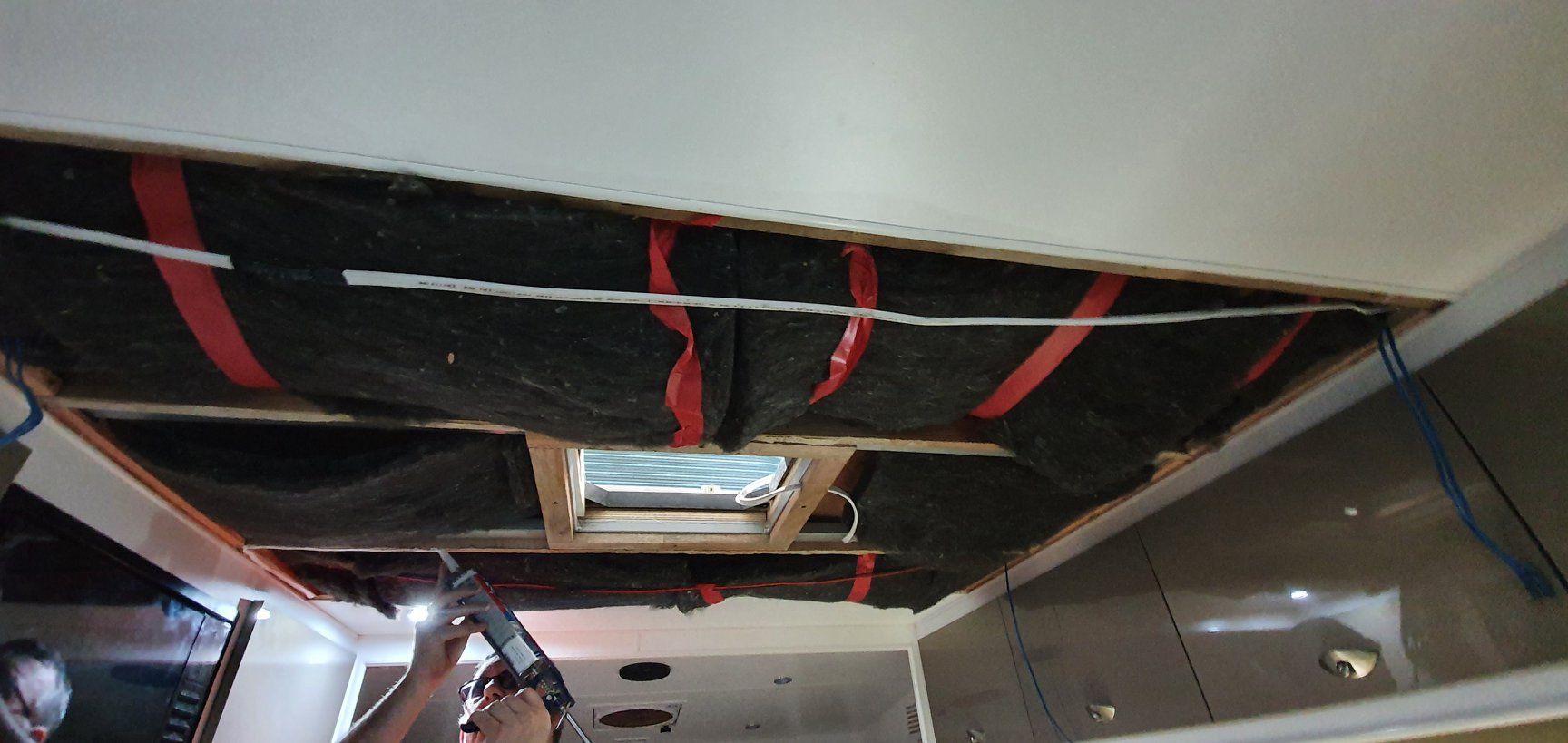 A Person is Working on the Ceiling of a Room With a Drill  — Dempsters Caravan & RV in Gladstone, QLD