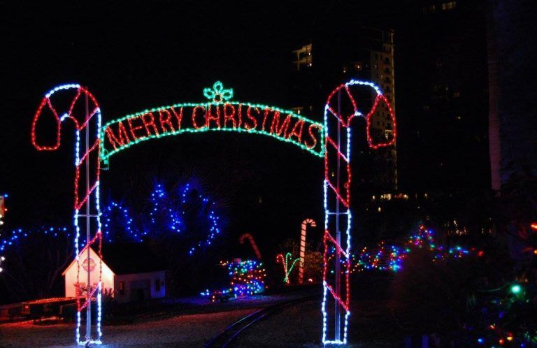 A merry christmas sign is lit up in the dark