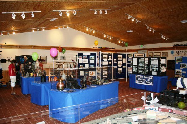 A room with blue tables and balloons and a sign that says ' historical society ' on it