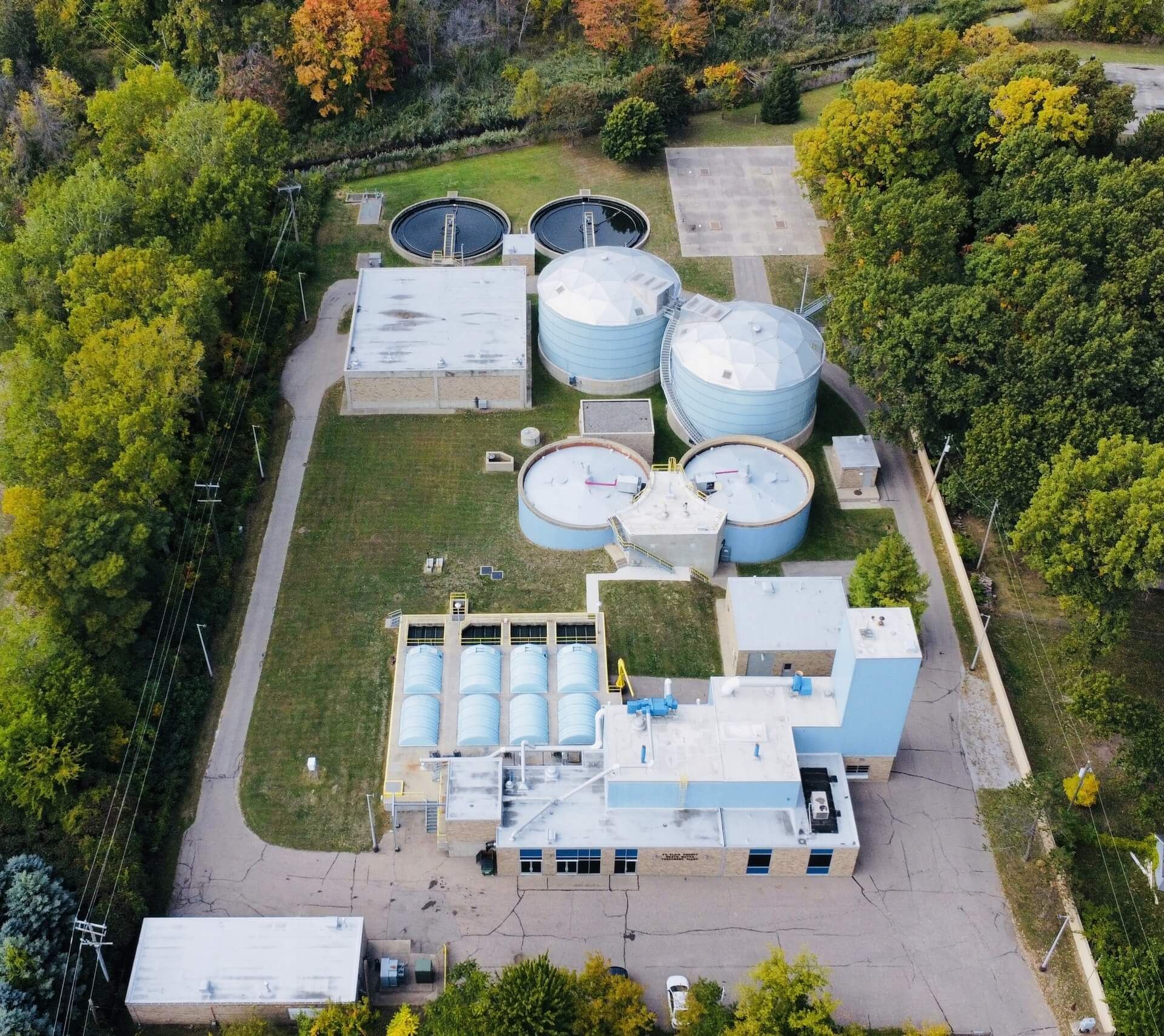 Aerial view of SWMUA industrial wastewater treatment plant surrounded by trees.