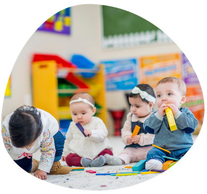 A group of babies are sitting on the floor playing with toys.