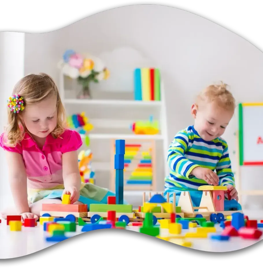 A boy and a girl are playing with toys on the floor.