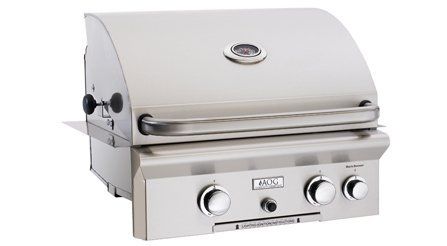 A stainless steel grill is sitting on a white surface.