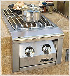 A stainless steel stove with pots and pans on it.