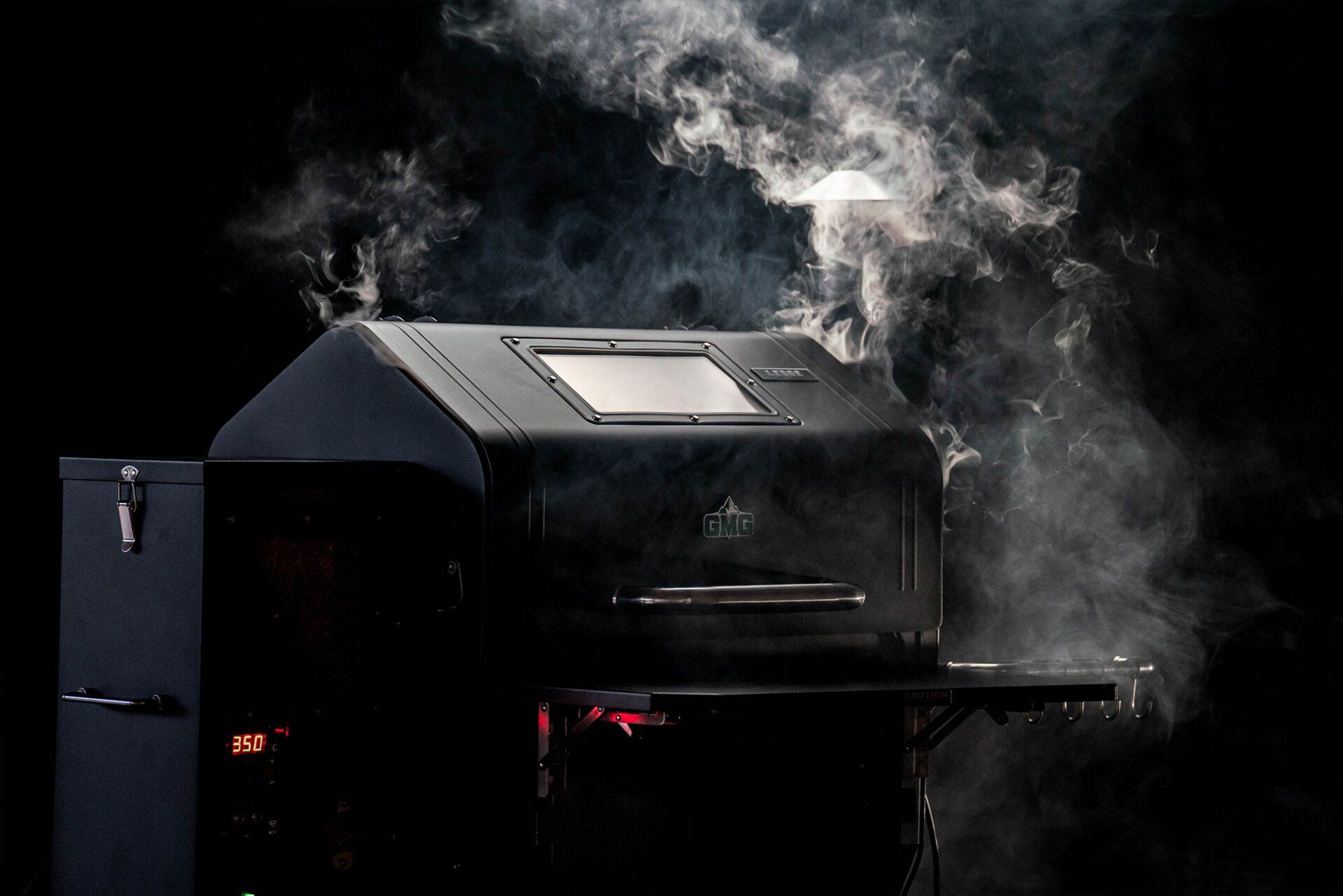 Smoke is coming out of a grill on a black background.