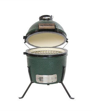 A green grill with the lid open on a white background