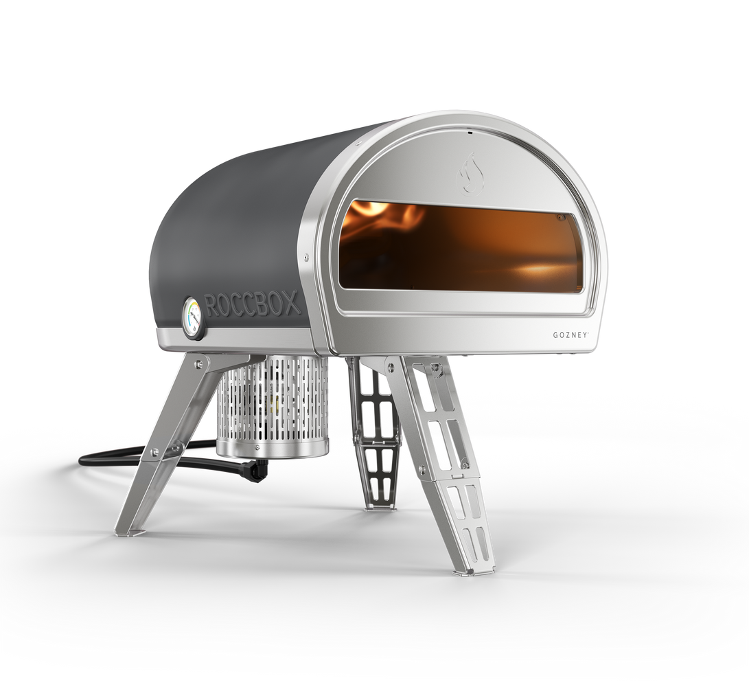 A black and silver pizza oven is sitting on a white surface.