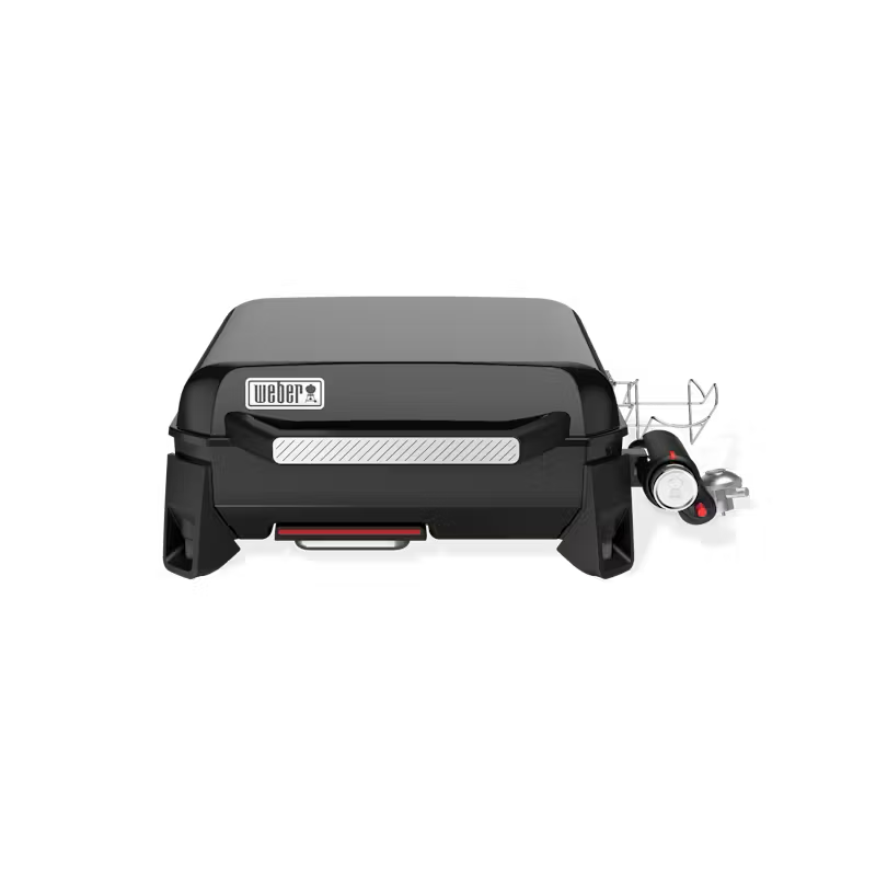 A black weber grill is sitting on a white surface.