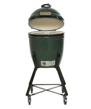 A green egg grill with the lid open on a stand.