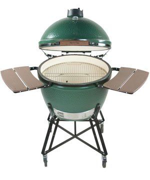 A green egg grill with the lid open on a white background.
