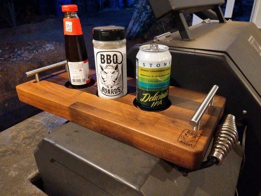 A wooden cutting board with a can of beer on it