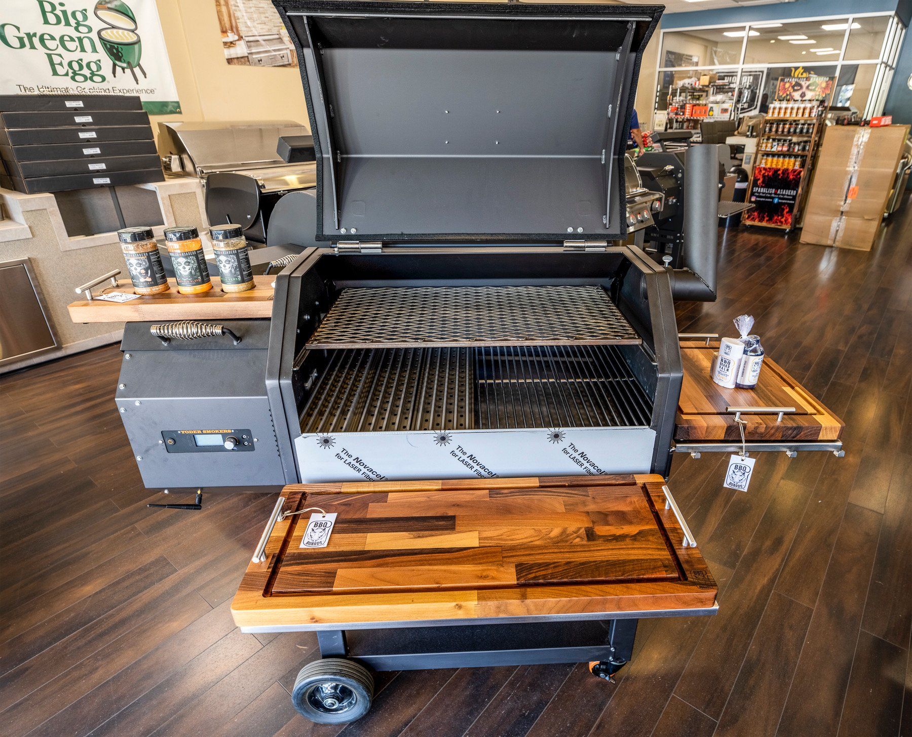 A grill with the lid open in a store with a sign that says buy green eggs