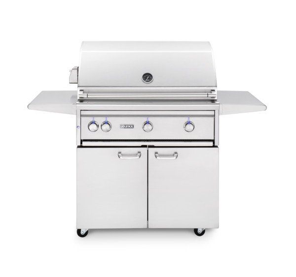 A stainless steel grill is sitting on top of a white cart.