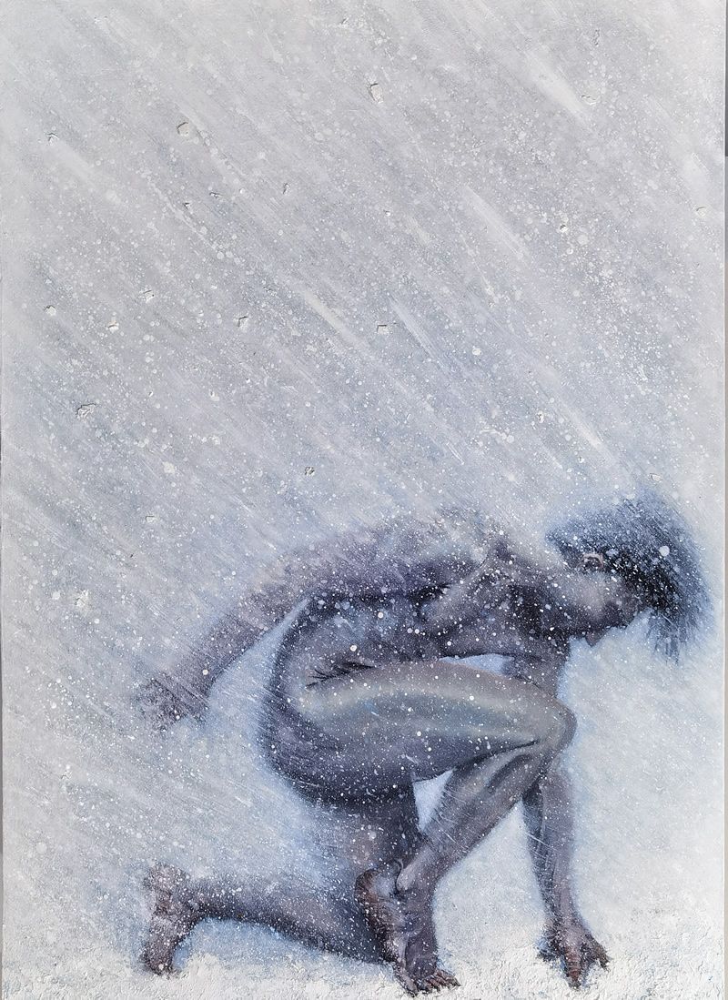 Man kneeling in the snow, facing down. Snowy, blue-toned figure in a winter scene.