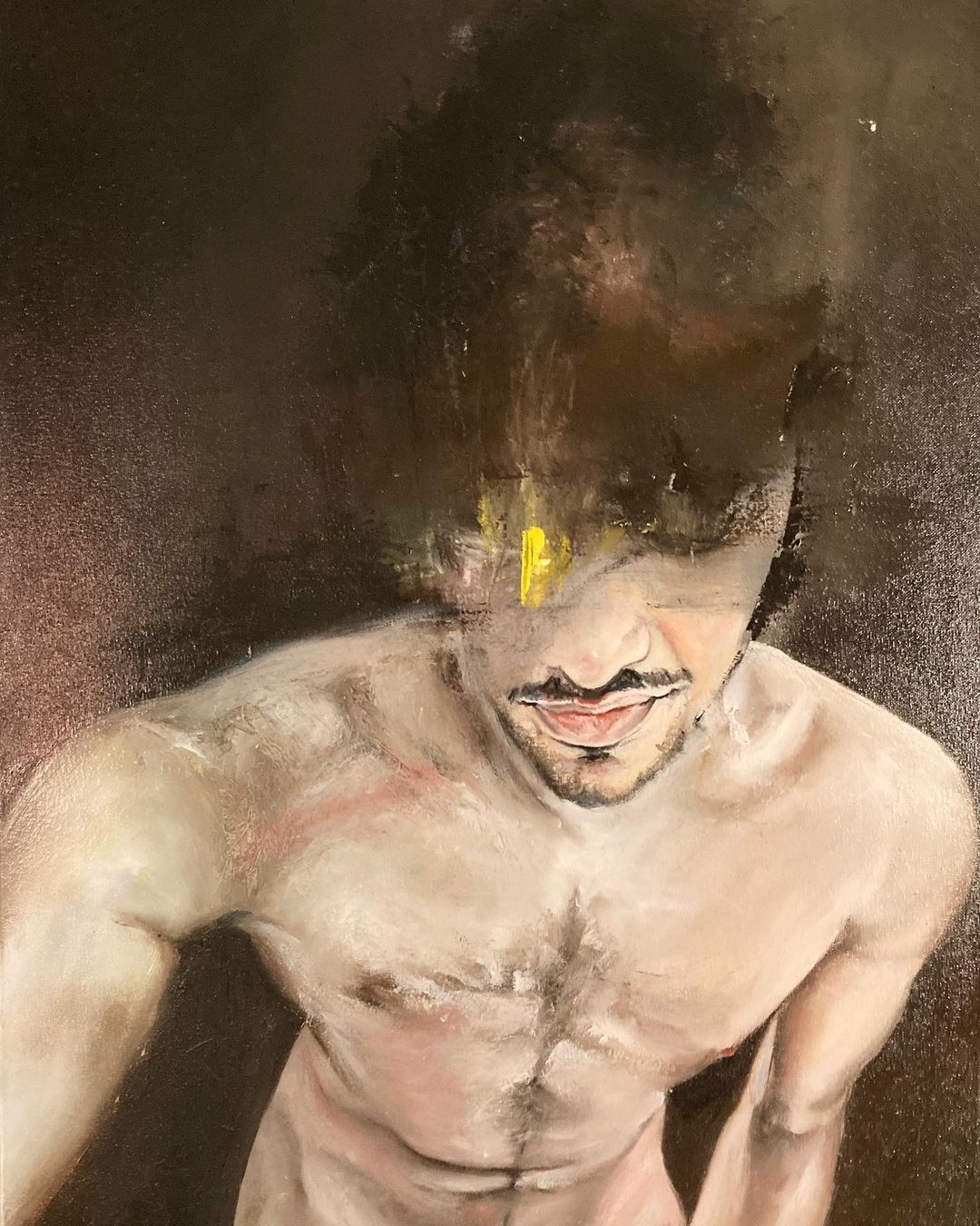 Nude self-portrait with blurred face; brown afro, light skin, mustache, dark background.