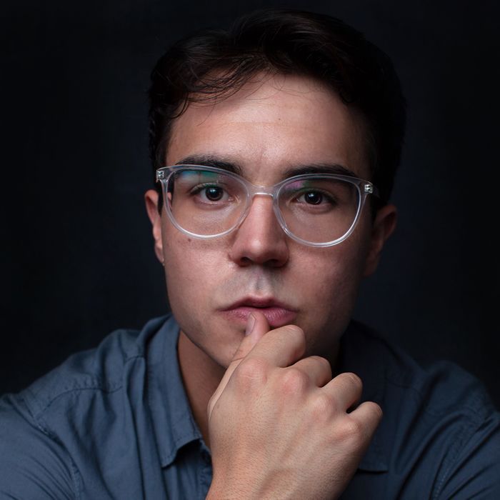 A man with glasses and a beard is smiling for the camera