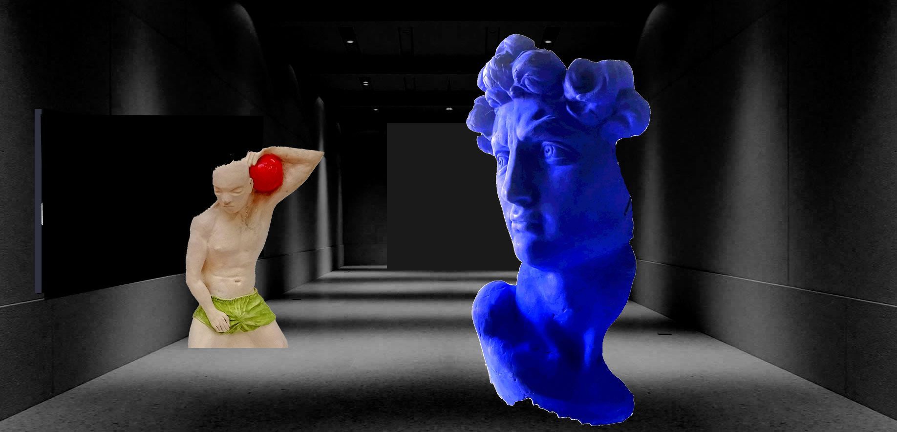 A long hallway with a sculpture of a blue face and a sculpture of a naked man with a red ball for a head.