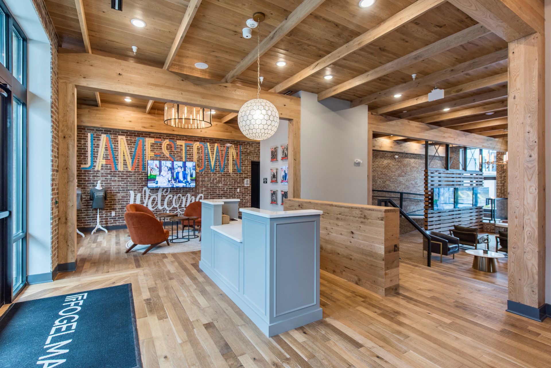 A large room with a wooden ceiling and a reception desk.