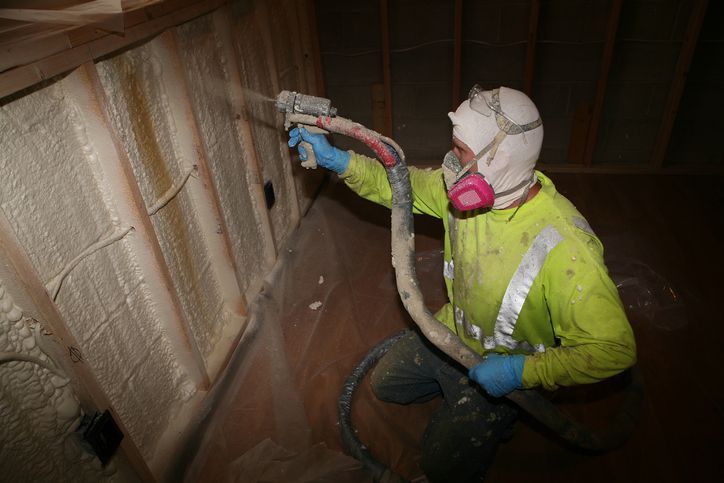 Man In Suit Adding Foam Insulation – Genoa, WI – Finney Foam
