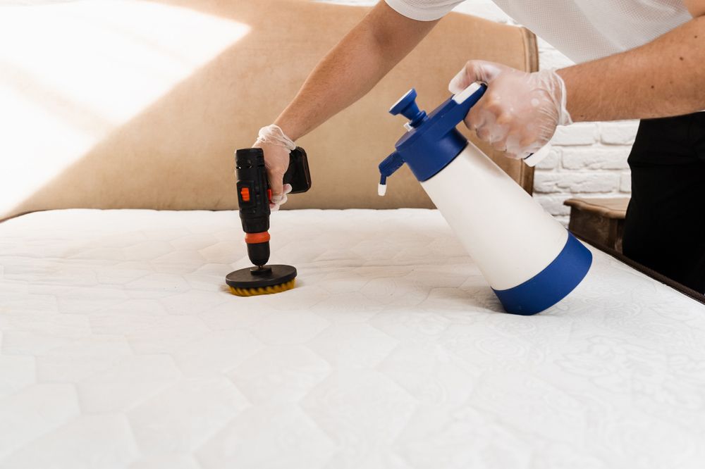 Person Cleaning a Mattress With a Spray Bottle — Kingaroy Carpet Cleaners in Nanango, QLD