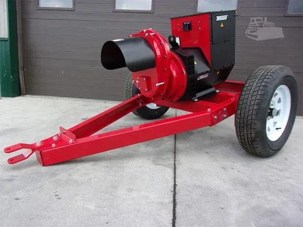 Red and black portable wood chipper with wheels, on a concrete surface.